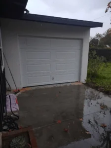 Garage door installation with clean concrete.