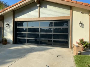 Modern black garage door installed on house.