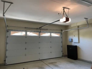 Garage door opener and tracks installed inside garage.