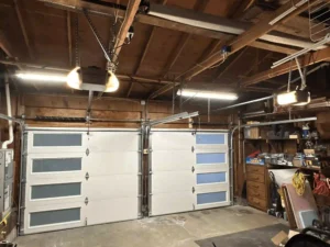 Two garage doors with windows installed in garage.