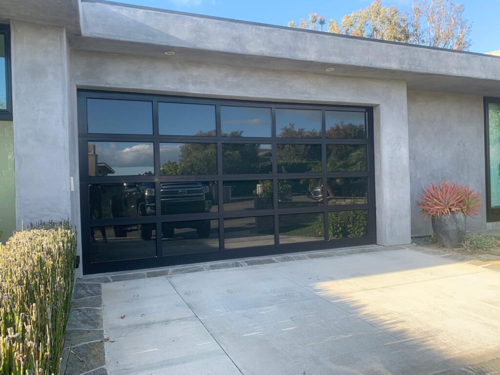Black aluminum glass garage door by Top One Garage Doors LLC