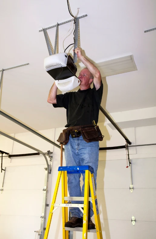 technician fixing the garage door operator
