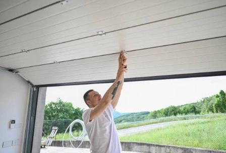 technician fixing the garage door