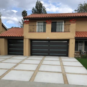 Single garage door with dark wood design and glass accents