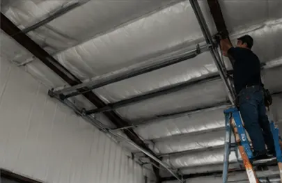Mechanic working on commercial garage door interior