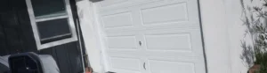 White garage door installed on house exterior.