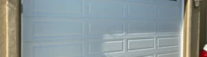 Close-up of white garage door with panels.