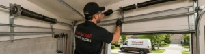Garage technician adjusting garage door springs and tracks